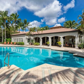 Spacious sparkling pool with sundecks and cabanas for lounging.